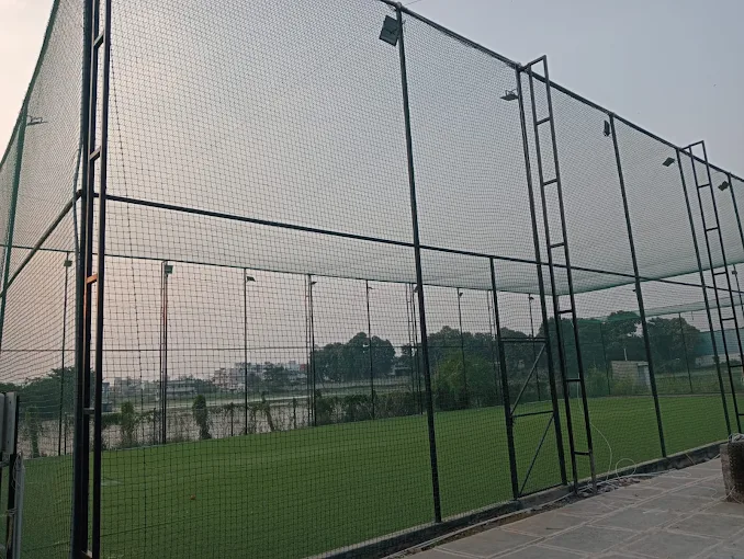 The full-height nets around the arena in daylight