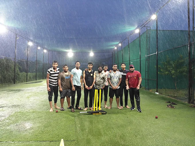 A team lined up mid-downpour under the floodlights
